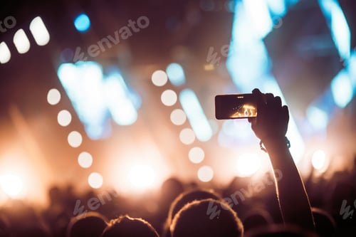 Preview: Cheering crowd with hands in air at music festival