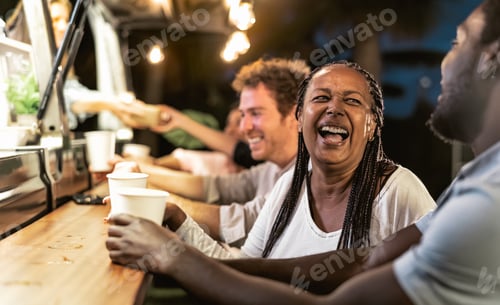 Preview: Happy multiracial people buying meal from street food truck market