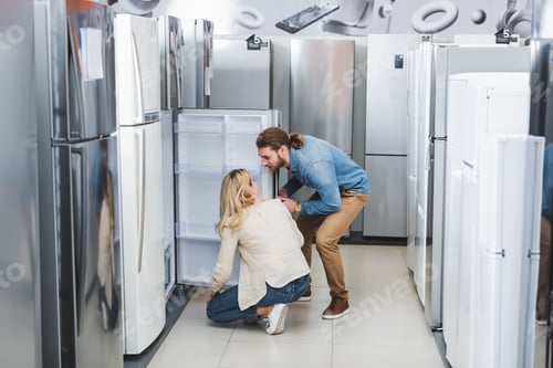 Preview: boyfriend and girlfriend talking near opened fridge in home appliance store