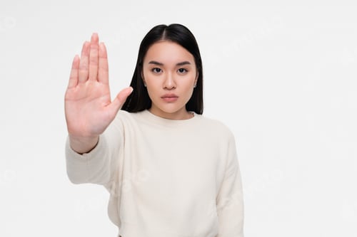 Preview: Woman Gesturing Stop with Outstretched Arm on White Background