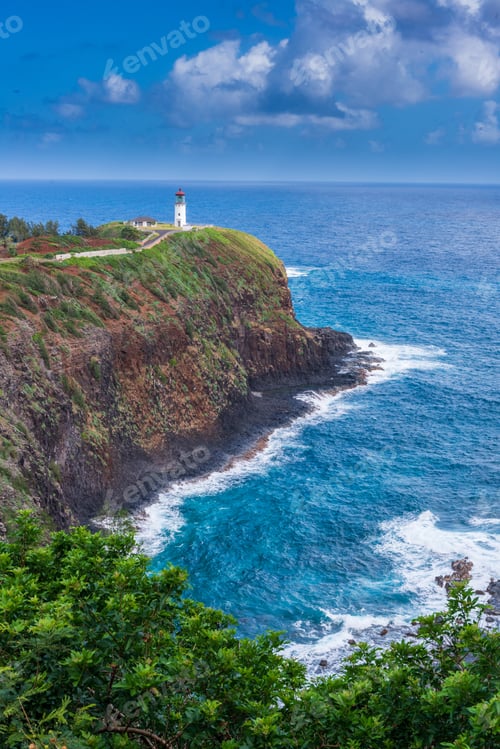 Preview: Vertical high angle shot of a lighthouse on top of a cliff by the sea