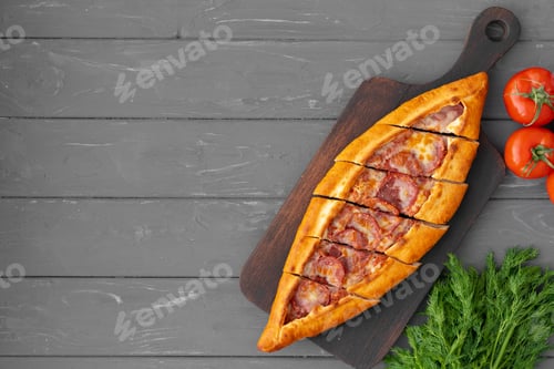 Preview: Turkish stuffed flatbread pide on gray wooden table