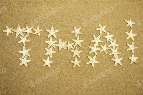 Preview: white starfish inscription of the word Thailand on the sand.