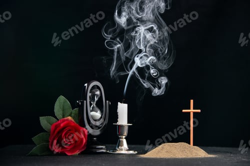 Preview: little grave with red flower and hourglass as memory on dark floor funeral israel death