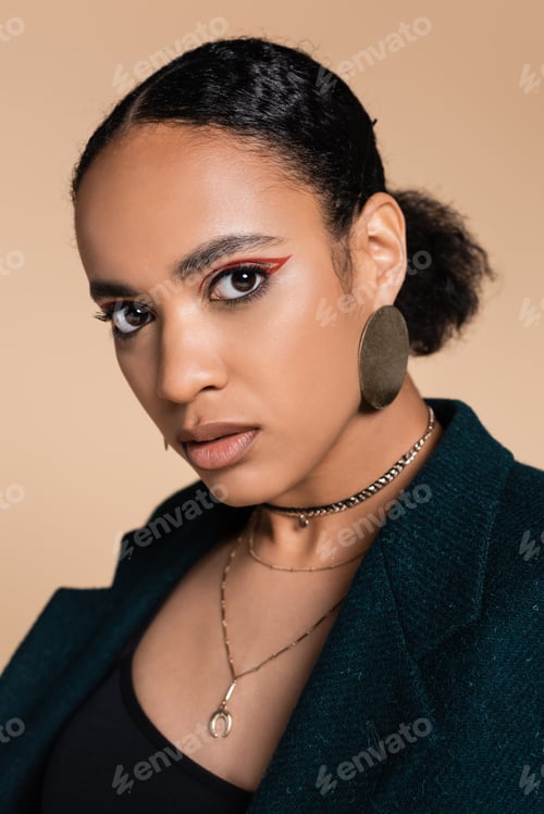 Preview: portrait of pretty african american model in woolen oversized blazer looking at camera isolated on
