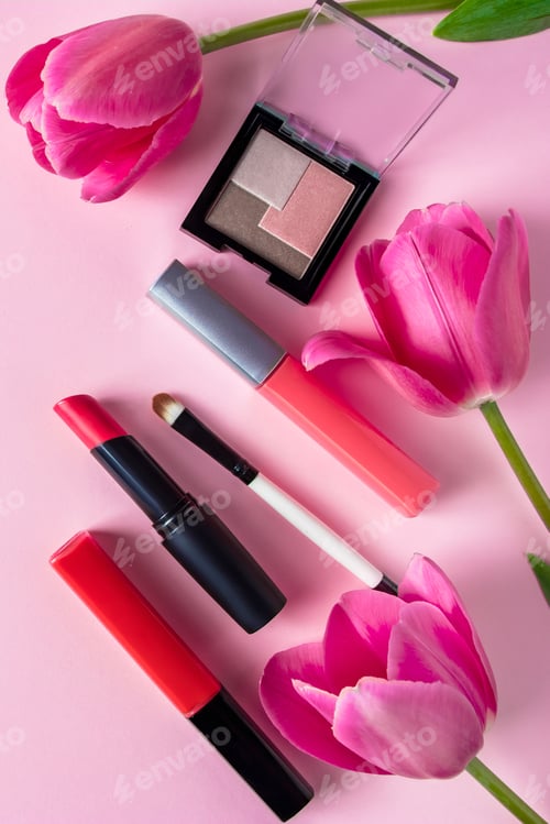 Preview: Set of cosmetics and flowers on a pink background. Makeup and beauty products.