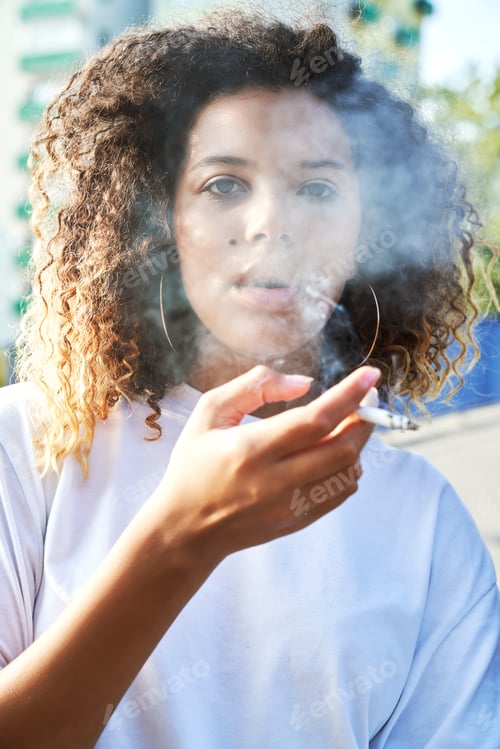 Preview: Portrait of young woman smoking cigarette