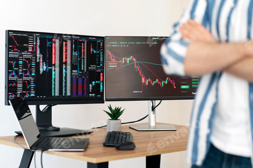 Preview: Trader standing in modern office, monitors with crypto chart on background, selective focus
