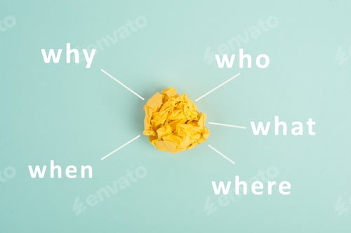 Preview: Crumpled up yellow paper on a bluec olored background, brainstorming, new idea, why, what, who
