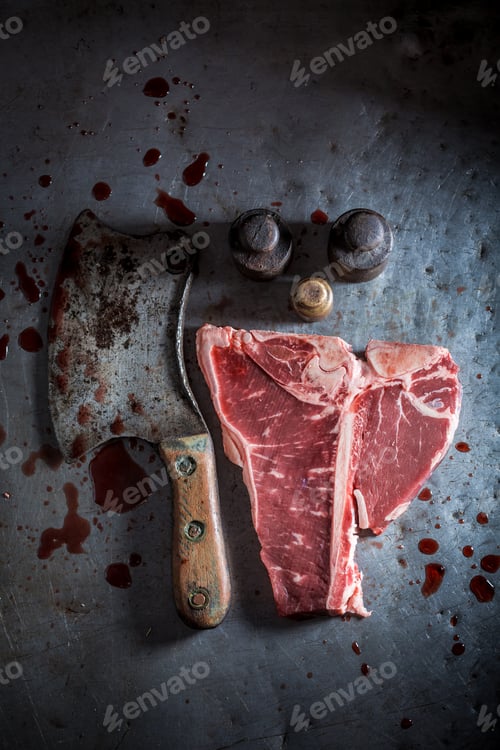 Preview: Raw red steak on old metal table