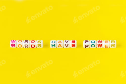 Preview: Text “Words have power” made from colorful beads on yellow background, closeup