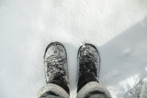 Preview: Top view on winter boots in snow. Winter season concept