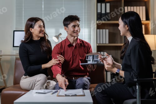 Preview: Couple discussing new house model with real estate agent