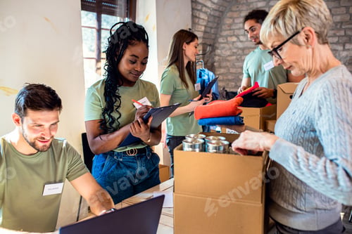 Preview: Group of volunteers with working in community charity donation center.