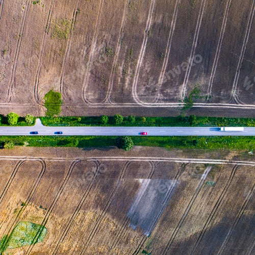 Preview: Aerial view of a country road between agricultural fields in Europe
