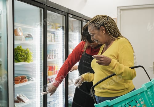 Preview: Supermarket employee helping a customer to choose