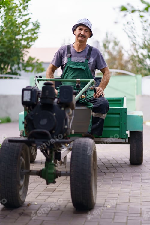 Preview: Male farmer with a walk-behind tractor