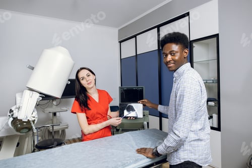 Preview: Happy doctor and patient in modern urology clinic, celebrating successful treatment.