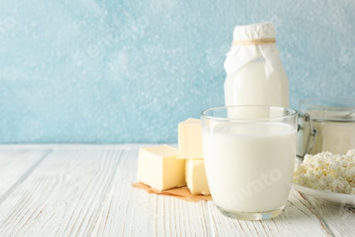 Preview: Different dairy products on white wooden table against blue background, copy space