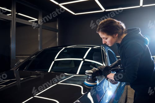 Preview: Woman Polishing Car in Professional Auto Workshop
