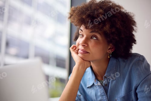 Preview: Thoughtful Young Businesswoman In Modern Office Working On Laptop Using Wireless Headset