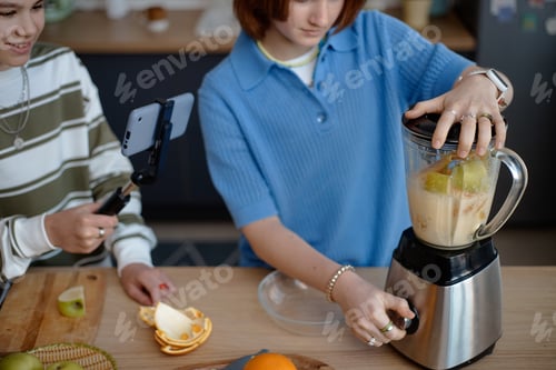 Preview: Boy and Girl Preparing Smoothie While Recording Video with Smartphone