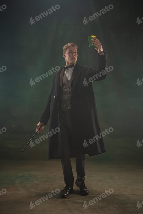 Preview: Young man in art action isolated on dark green background. Retro style, comparison of eras concept