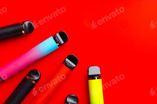 Preview: Colorful disposable electronic cigarettes on red background