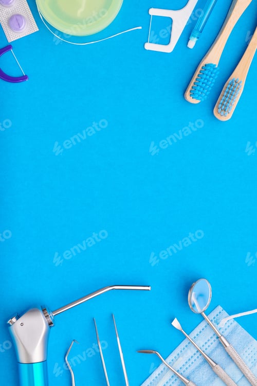 Preview: Dentist tools over blue background top view