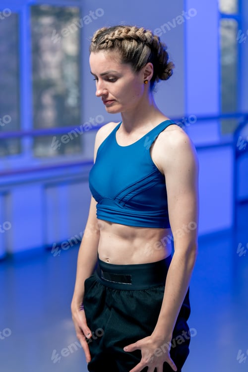 Preview: close up in studio of spiritual development master class girl standing meditates in a blue top and