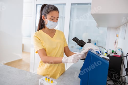 Preview: Science veterinarian working with microscope in lab