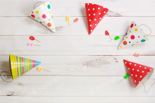 Preview: Party hat and candles on wooden background.