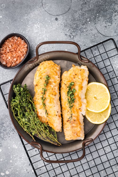 Preview: Baked Cod fish fiilet, fried whitefish meat. Grey background. top view