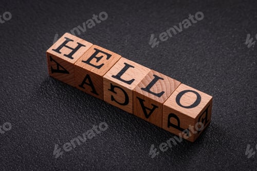 Preview: The inscription hello on wooden cubes on a dark concrete background