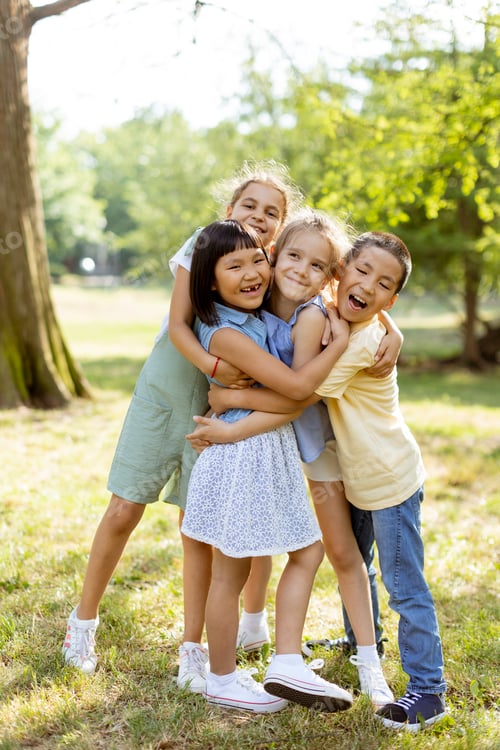 Preview: Group of asian and caucasian kids having fun in the park