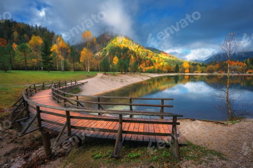 Preview: Mountain lake, colorful trees and wooden bridge in autumn