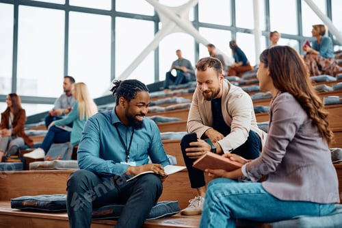 Preview: Group of entrepreneurs communicating on a break during business seminar at convention center.