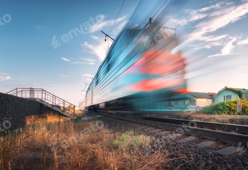 Preview: High speed passenger train in motion on the railroad at sunset
