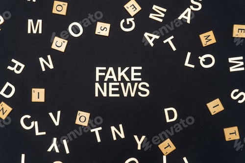 Preview: FAKE NEWS word written on dark paper background. FAKE NEWS text for your concepts