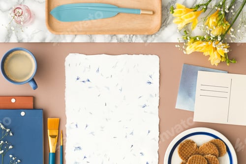 Preview: Top view on mockup of paper between postcards and yellow flowers