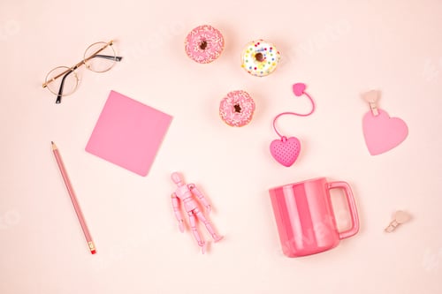 Preview: Flat lay with pink accessories, tea cup and donuts over light pink background. Top view. Morning