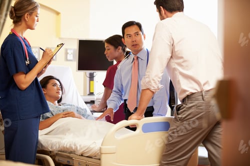 Preview: Medical Team Meeting Around Female Patient In Hospital Room