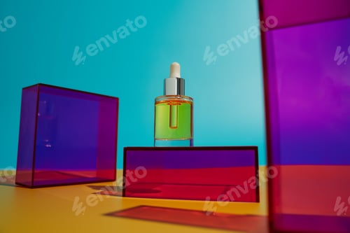Preview: Face oil in glass bottle on yellow and blue background with pink and purple geometric elements