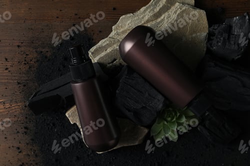 Preview: A bottle with natural, charcoal cosmetics on a wooden background.
