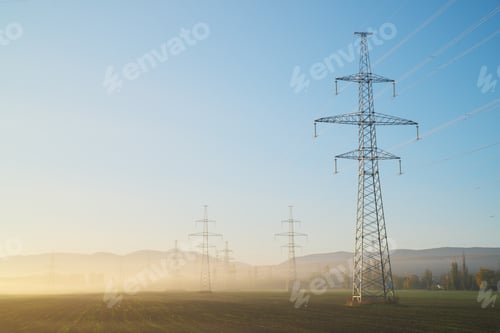 Preview: High voltage electricity tower at sunrise.