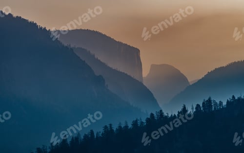 Preview: Drone shot of green-covered hills in Yosemite National Park Valley at dawn