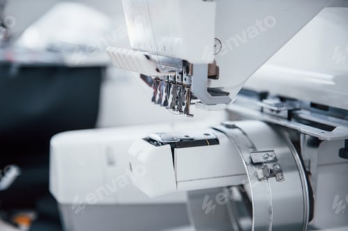Preview: Close up view of white automatic sewing machine at factory
