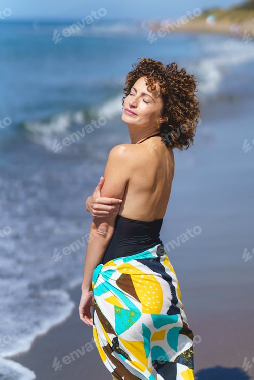 Preview: Stylish woman enjoying nature at seashore