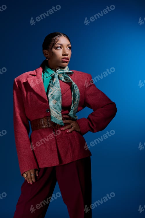 Preview: Stylish young woman showcases smart casual fashion in vibrant studio backdrop