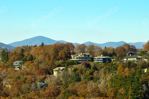 Preview: Aerial view of big family houses on mountain top between yellow trees in North Carolina